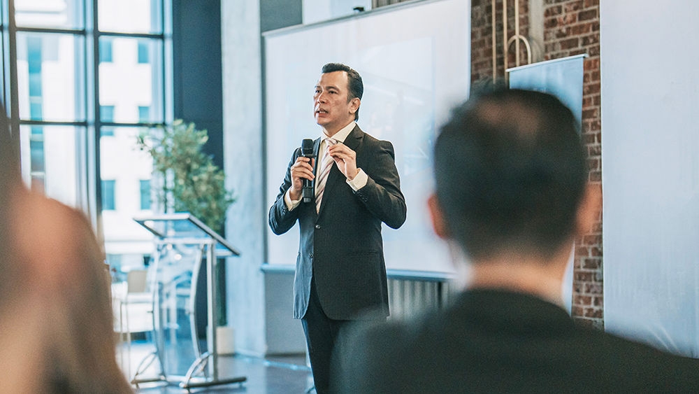 Asian mature businessman coaching, motivation speech in business conference meeting seminar during convention center